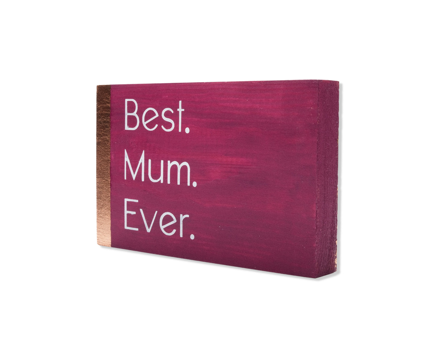 Small freestanding rectangular wooden sign displayed at 35 degree angle to show depth of sign. Magenta color, with bronze rose gold vertical border on left side only. White painted message, Best. Mum. Ever. Studio style photo on white background.
